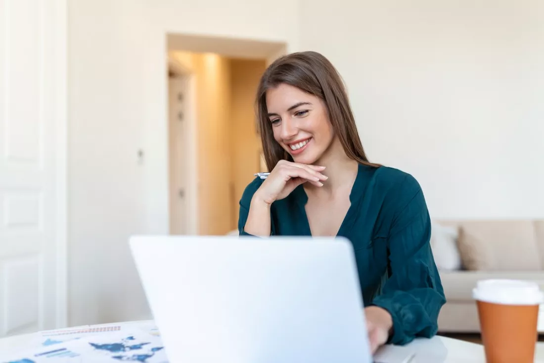 A young woman looking for jobs on her laptop